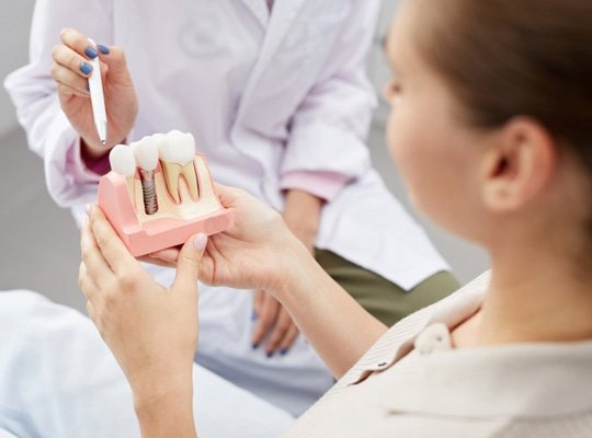 a patient learning about how dental implants work