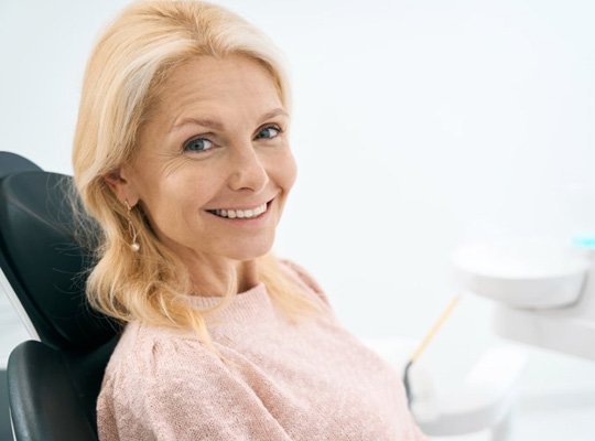  woman smiling after receiving dental implants in Parma Heights