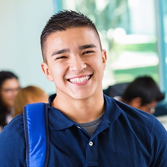 Grinning teen boy wearing backpack