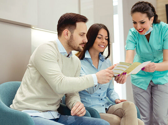 Dentist explaining membership plans to a couple