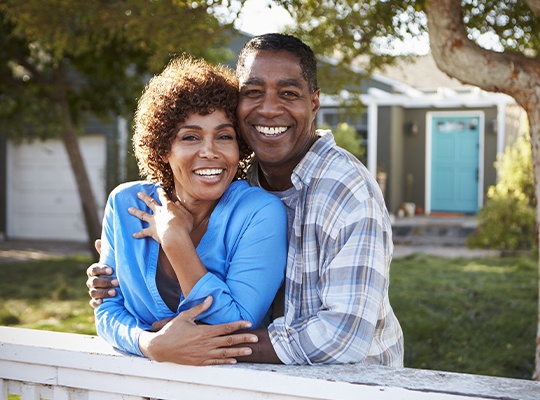 Smiling older man and woman outdoors