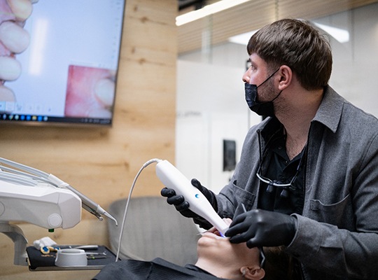 A dentist taking digital impressions of a patient’s mouth