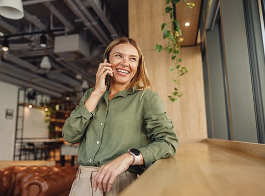 Woman smiling while talking on phone