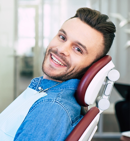 Man in dental chair smiling