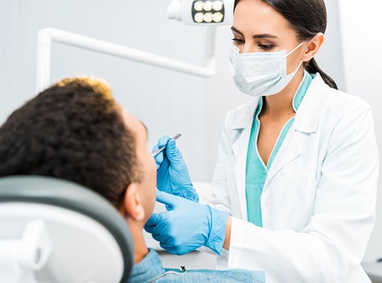 Dentist performing dental exam on patient