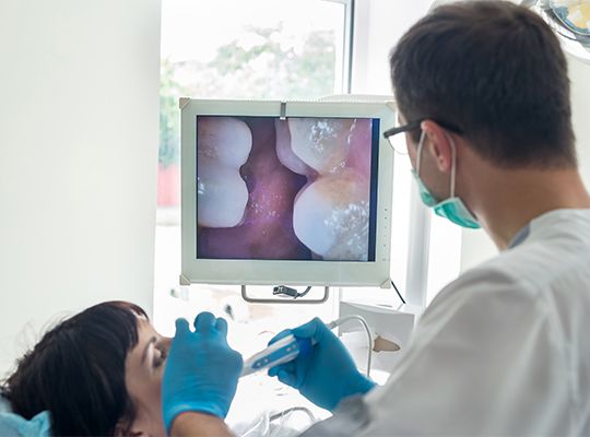 Dentist and patient looking at intraoral images