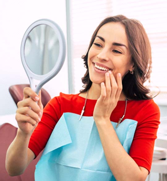 Woman admiring results of teeth whitening in Parma Heights