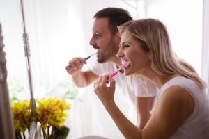 couple brushing their teeth