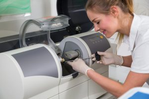 technician using cerec milling machine