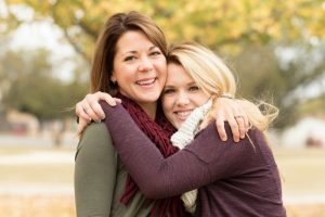 A mother and daughter hugging.