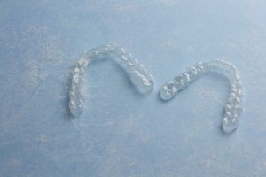 A pair of clear aligners on a table.