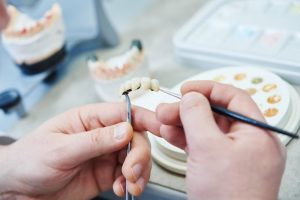 dentist holding dentures