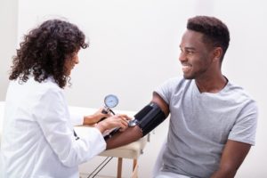 doctor checking a patients' blood pressure