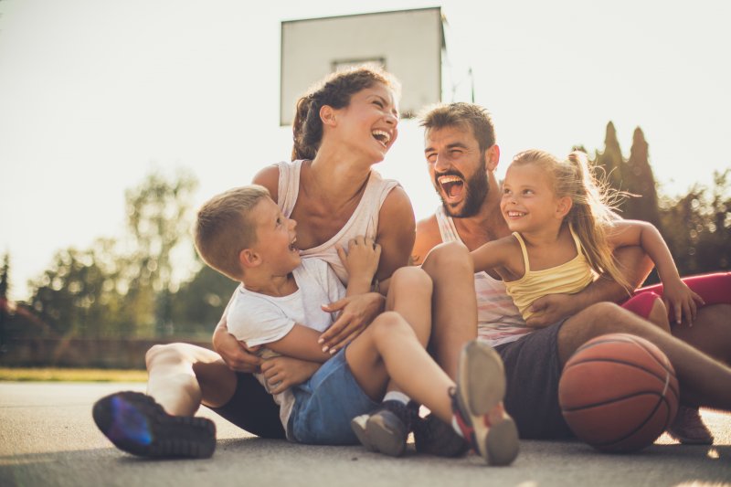 family playing basketball during summer