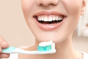 a close up of a patient brushing her teeth in Parma Heights