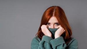 woman covering her mouth from embarrassment