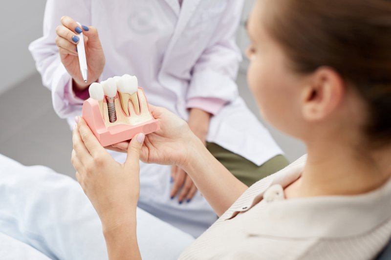 A dentist explaining dental implants to her patient