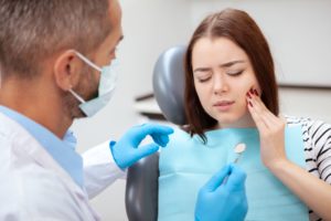 Woman in pain in dentist's chair